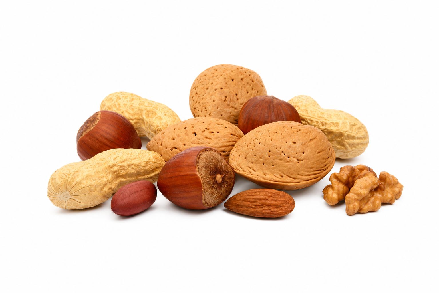 A compact arrangement of mixed nuts isolated on white